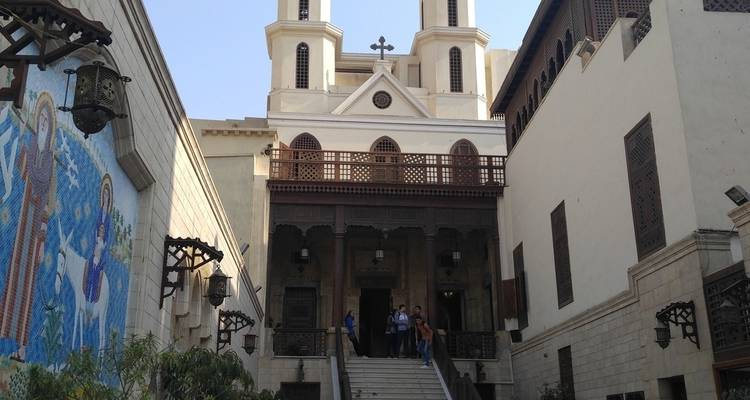 Entrance of a historical building with people on the steps.