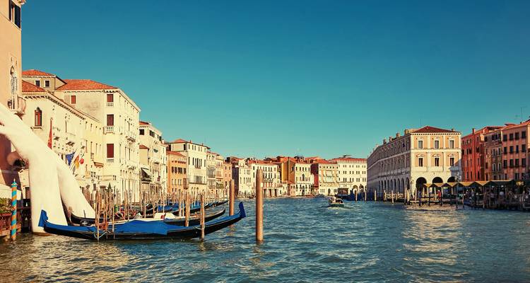 Classic view down Venice's Grand Canal with gondolas and pastel palazzi.