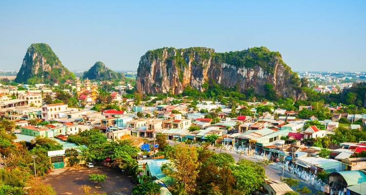 Panoramic view over Marble Mountains and sprawling city with jagged limestone outcrops.