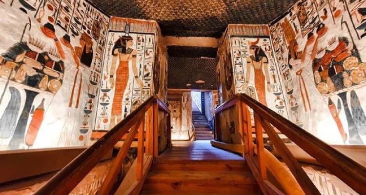 Well-lit Egyptian tomb with vibrant frescoes.