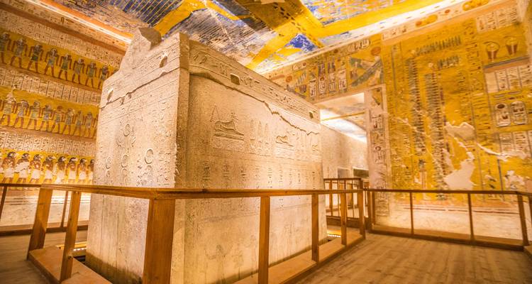 Interior of an Egyptian tomb with colorful decorations.