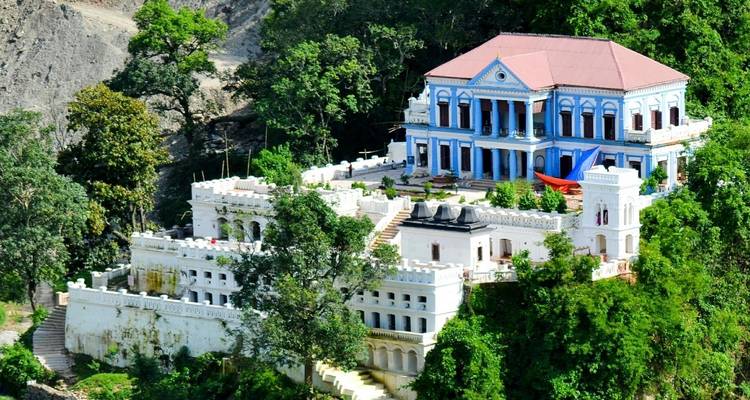 Palace set in lush green hills, architectural landmark.