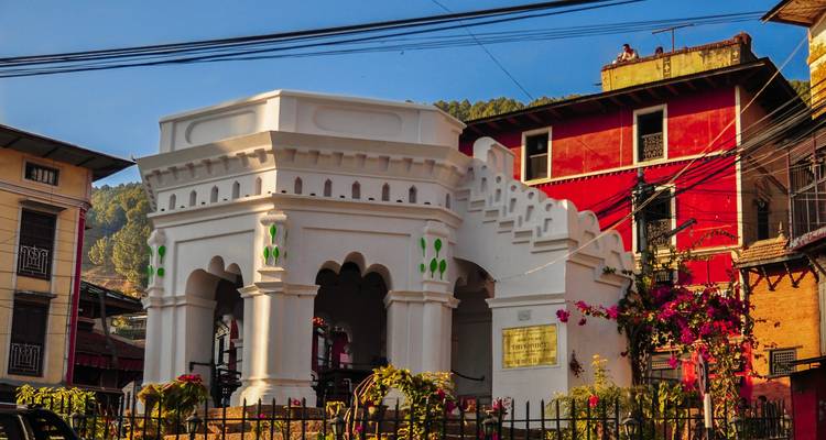 Historic structure surrounded by colorful buildings.