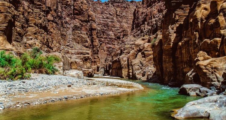 Rocky canyon with a clear water stream.