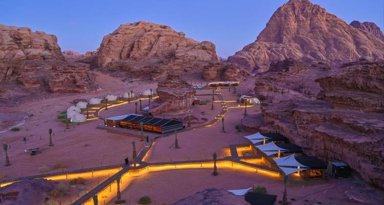 View of Wadi Rum camp with tents and mountains.
