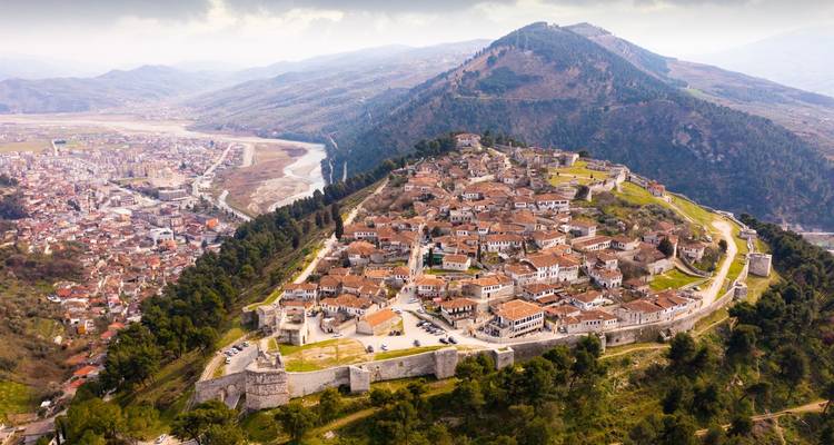 Aerial view of a historic hilltop fortress town.