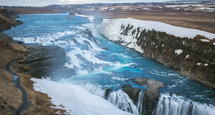Powerful waterfall with icy landscape surrounding Gullfoss.