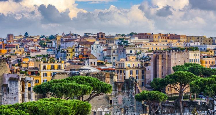 Panoramic view of Rome with historical ruins and cityscape.