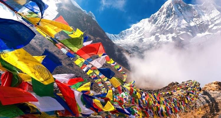 Gebedsvlaggen die leiden naar een besneeuwde bergtop.