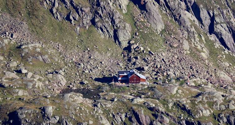 Berghut genesteld in een rotsachtig landschap.