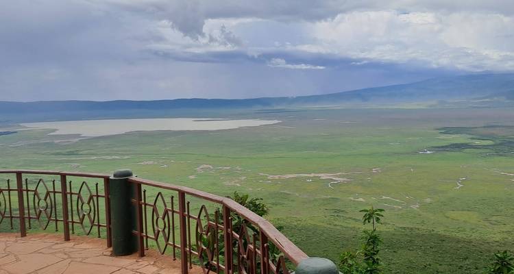 Panoramic view of a large crater with an observation deck.