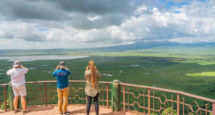 Tourists observing the Ngorongoro Crater landscape from a lookout.