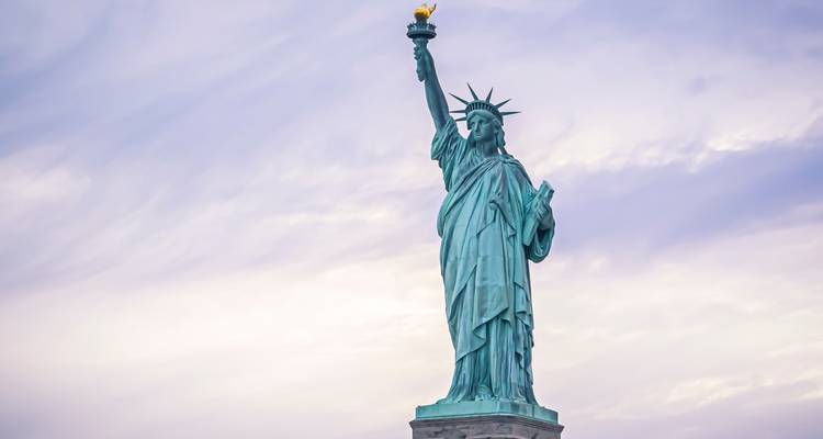 The Statue of Liberty against a cloudy sky.