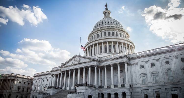 The U.S. Capitol building against a partly cloudy sky
