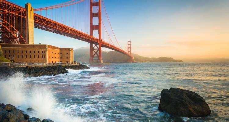 Golden Gate Bridge mit einem Fort und tosenden Wellen.