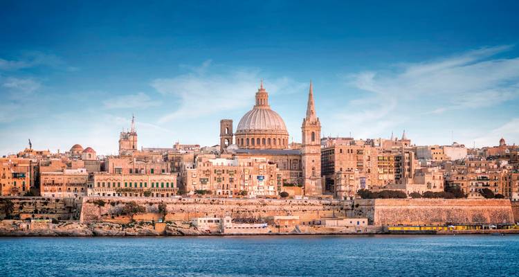 Coastal cityscape with historic buildings and blue sky