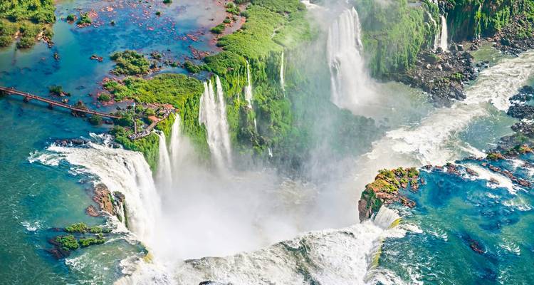 Aerial view of Iguazu Falls with surrounding greenery.