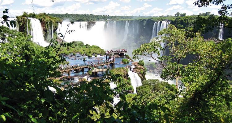 View of tourists on a walkway at Iguazu Falls.