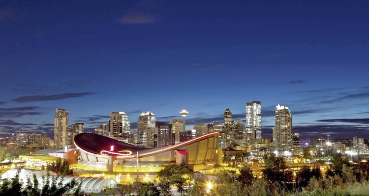 Calgary skyline with distinctive buildings at night.