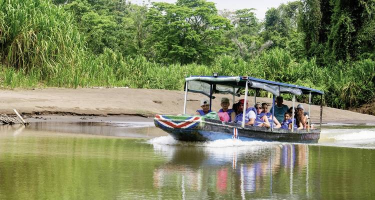 Tourists in a safari boat on a river.