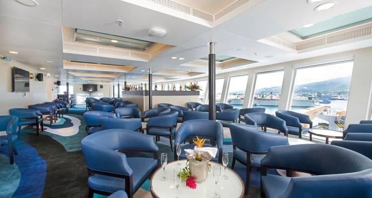 Lounge area with seating and table setup on a ship.