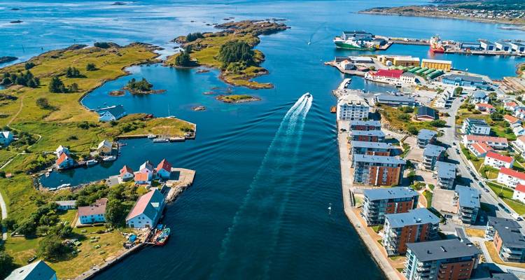 Coastal city with waterfront buildings and boats.