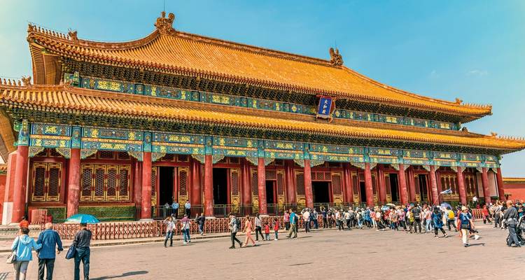 Colorful historical Chinese palace with tourists.
