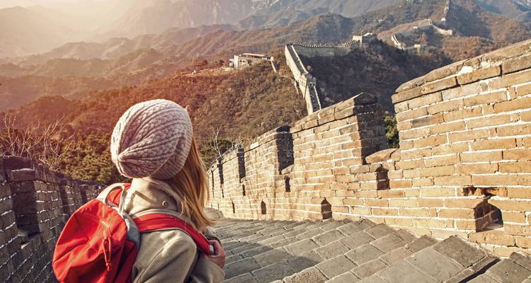 Tourist on the Great Wall of China admiring the view.