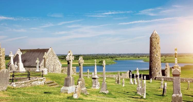 Ancient stone tower and crosses on a hill.