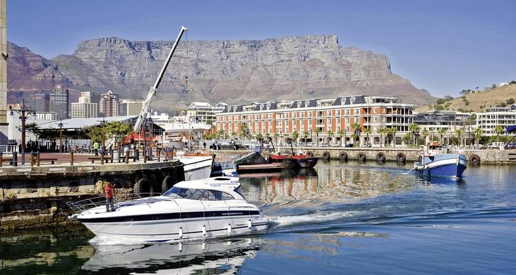 Harbor view with boats and Table Mountain in the background.