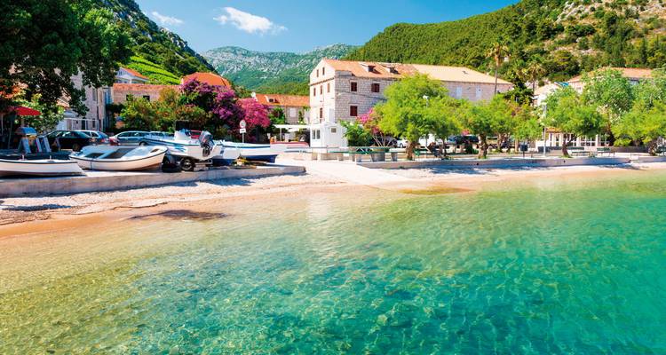 A coastal village with clear turquoise waters.