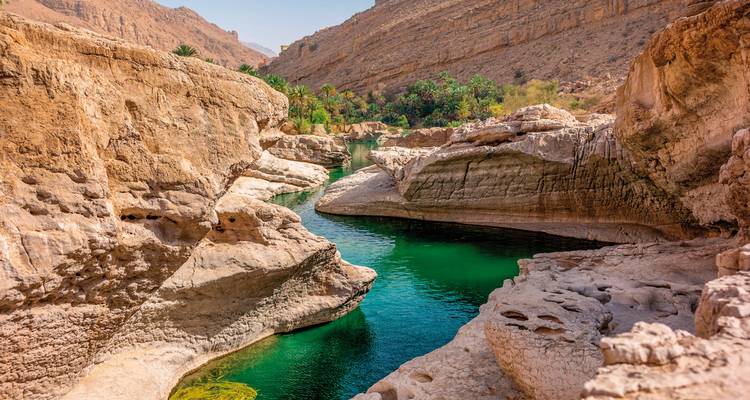 A rugged canyon with clear green water.