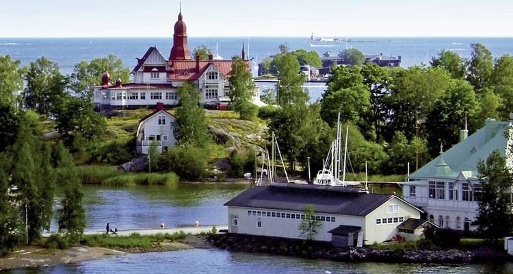 A scenic island with charming houses and boats in the water.