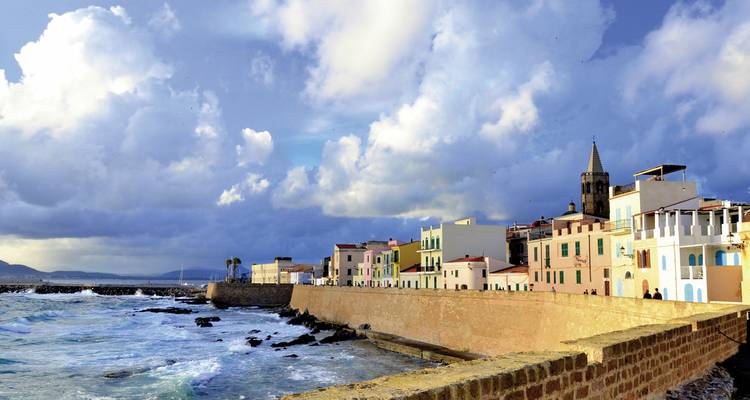 A coastal town with colorful buildings and a church by the sea.