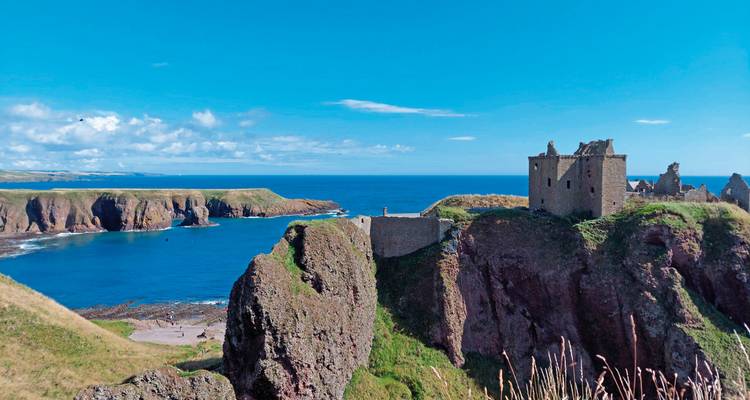 Dramatic cliffside with an ancient castle overlooking the sea.