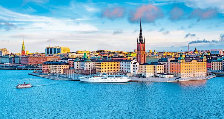 Scenic cityscape by the water with a tower.