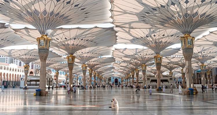 The architecture of a large, open square with umbrella structures.