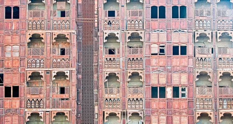 Facade of a traditional building with intricate window designs.