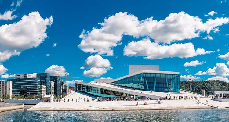 Modern opera house by the water on a sunny day.
