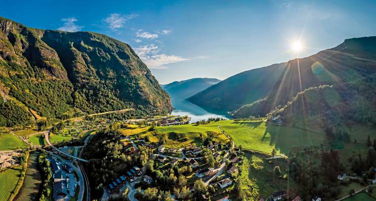 Panoramic view of a valley with sunlight streaming in.