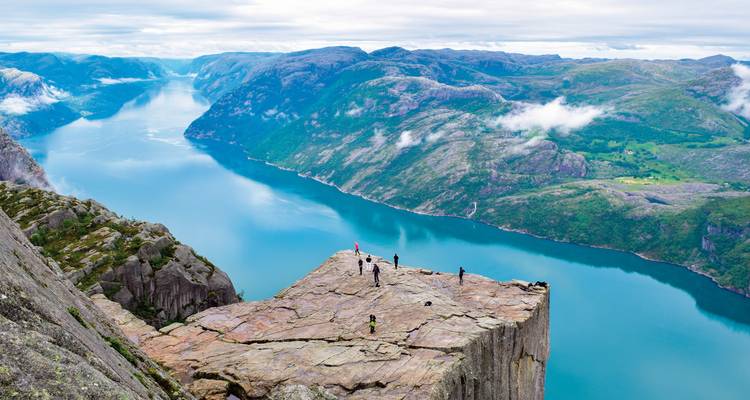Famous cliff formation above the fjord with people enjoying the view.