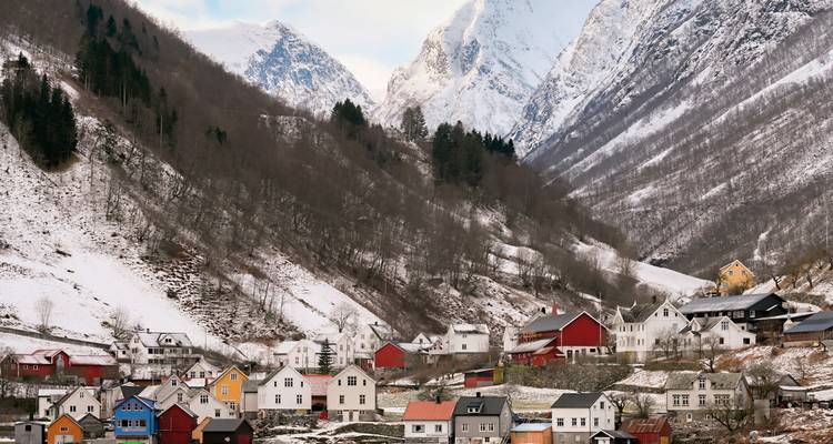 Snowy village surrounded by mountains.