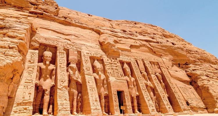 Carvings of pharaohs and deities on temple walls.