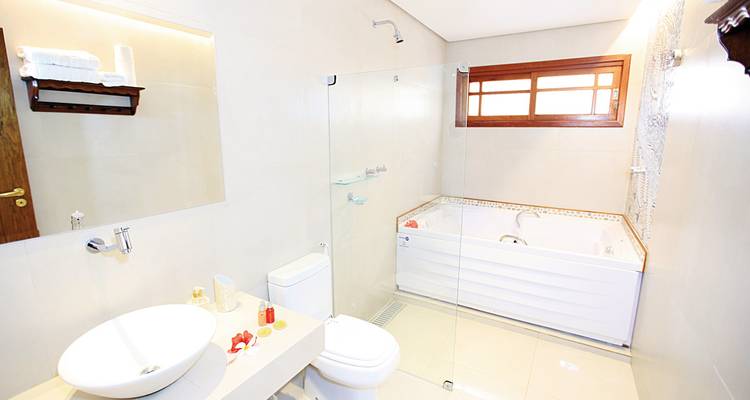 Modern bathroom with a clean design, a large bathtub, and glass shower enclosure.