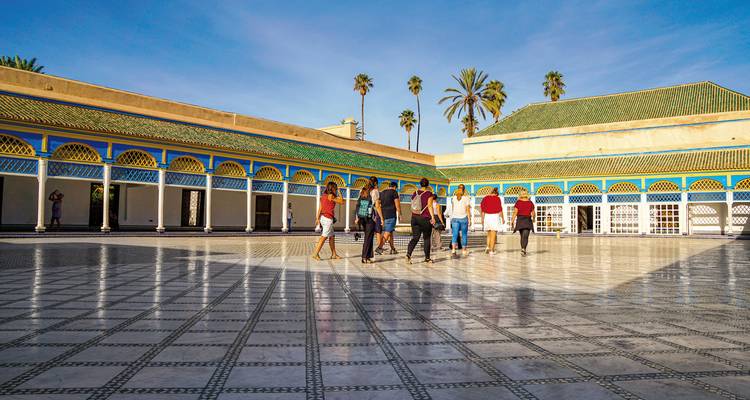 Een groep toeristen die een paleisbinnenplaats verkent.