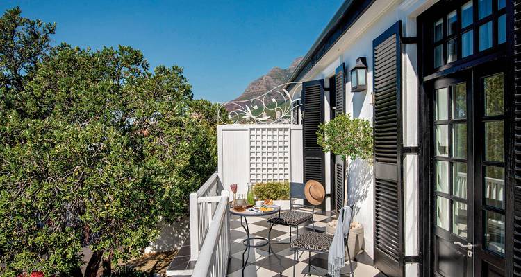 Balcony view with mountains and stylish outdoor setting.