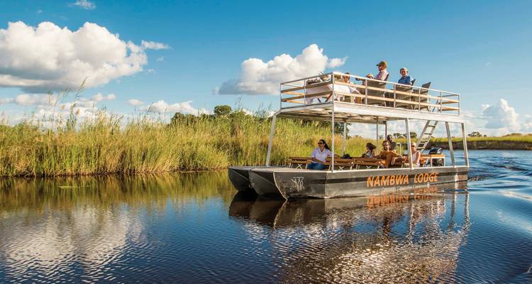 Guests on a boat tour through a waterway.