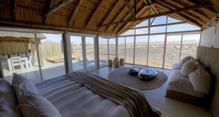 Luxe room with panoramic desert views and modern decor.