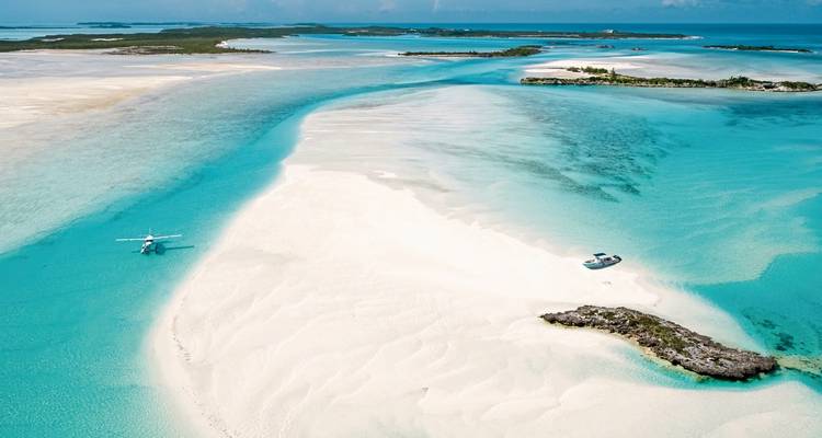 Aerial view of sandbanks and turquoise water in the Bahamas.