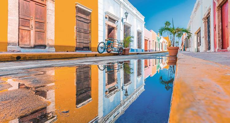 Colorful colonial street with reflections in water